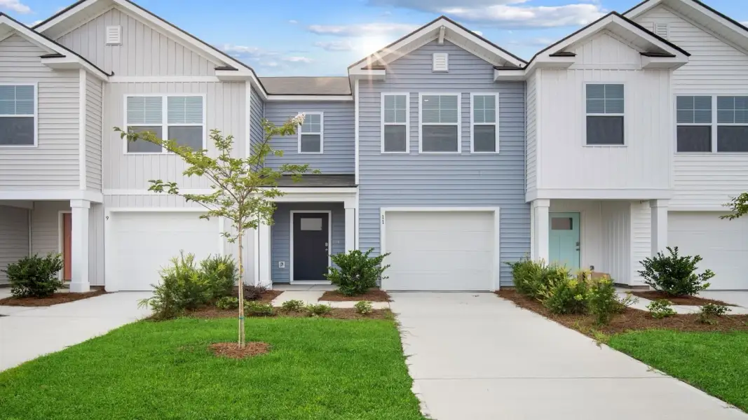 Front exterior of a new home in Old Bailey Towns, Ridgeland, SC, highlighting curb appeal (Image 1). Front exterior of a new home in Old Bailey Towns, Ridgeland, SC, highlighting curb appeal (Image 1).