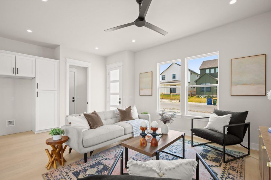 Living room featuring light wood-style floors, recessed lighting, and a ceiling fan