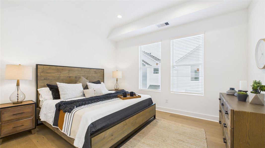 Bright and spacious, this spacious primary bedroom is filled with natural light and features two generous closets, his and hers, along with a well-sized primary bathroom, creating a bright and comfortable retreat with ample storage and luxury.