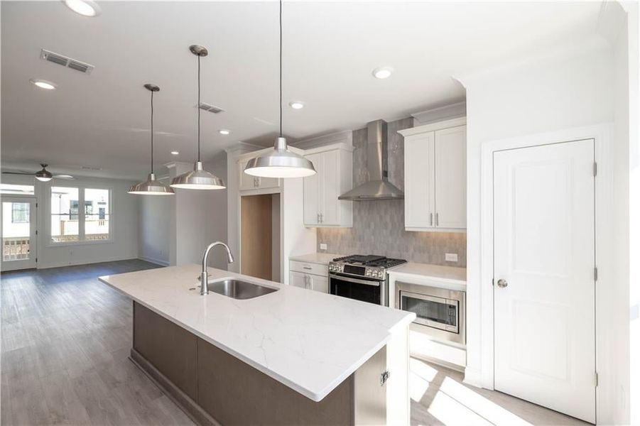 tile backsplash in the kitchen - pendent lighting - Pictures represent a previously built home not the actual home tile backsplash in the kitchen - pendent lighting - Pictures represent a previously built home not the actual home