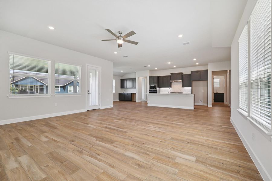 Unfurnished living room with a ceiling fan, light wood-style floors, and recessed lighting