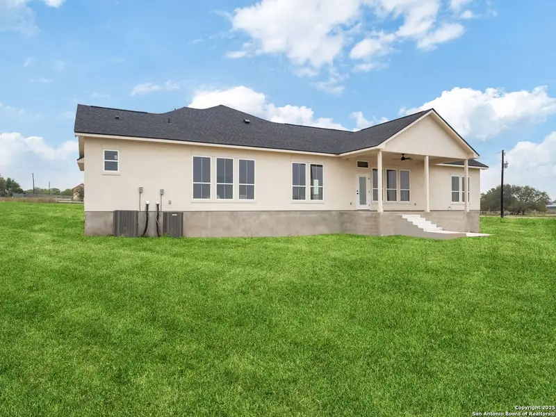 Front exterior of a new home in , La Vernia, TX, highlighting curb appeal (Image 1).