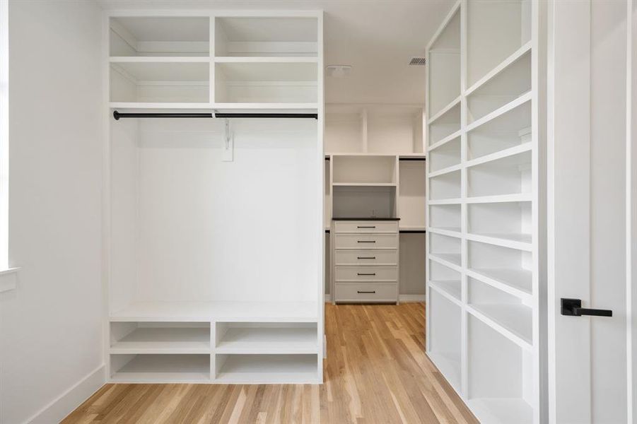 Walk in closet featuring light wood-style floors Walk in closet featuring light wood-style floors
