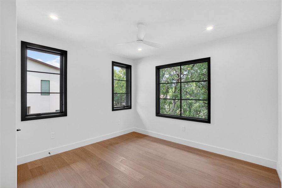 Hardwood floors and generous windows create an airy, bright space.