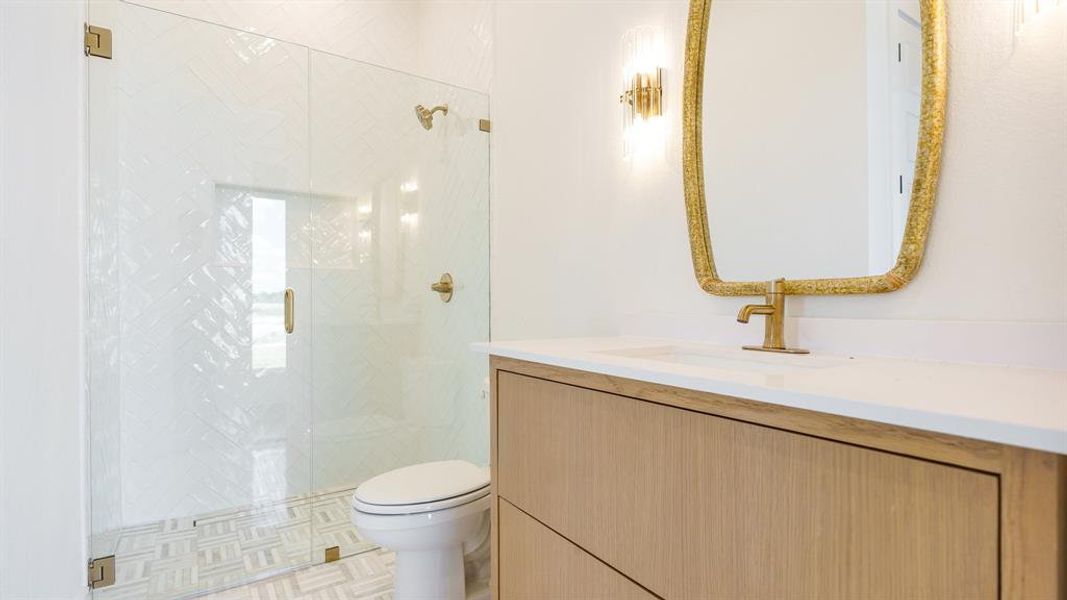 Bathroom featuring tile flooring, an enclosed shower, toilet, and vanity