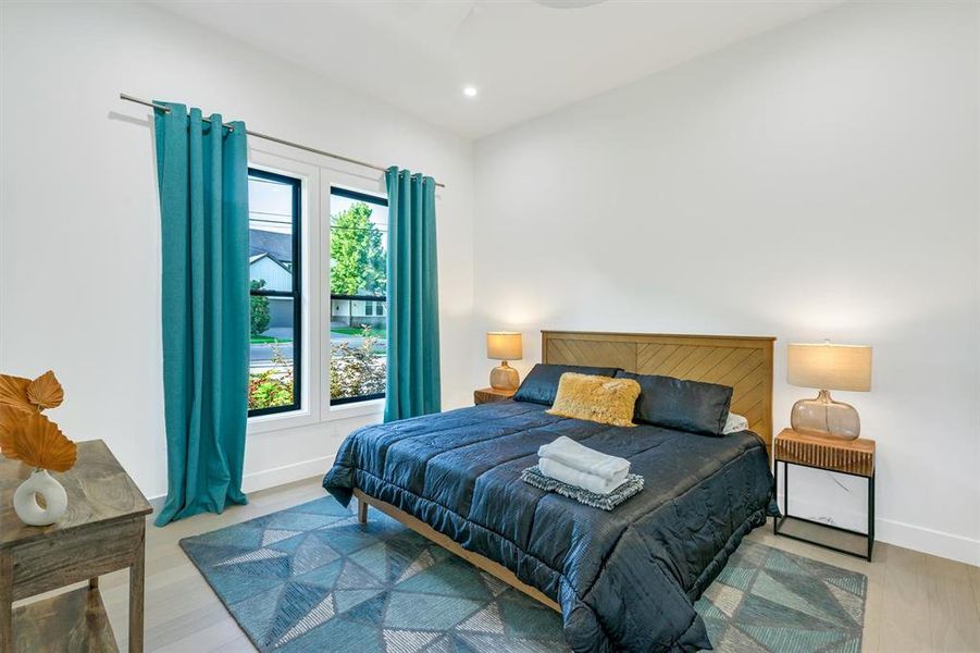 Bedroom with light wood-type flooring and recessed lighting