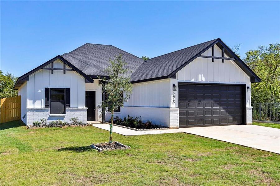 Modern farmhouse with a garage and a front lawn