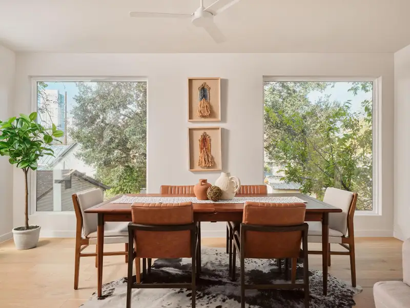 Dining area with healthy amount of natural light, light wood-style flooring, and ceiling fan