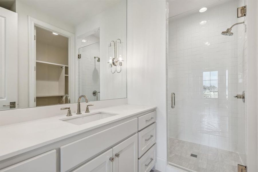 Bathroom featuring vanity and walk in shower