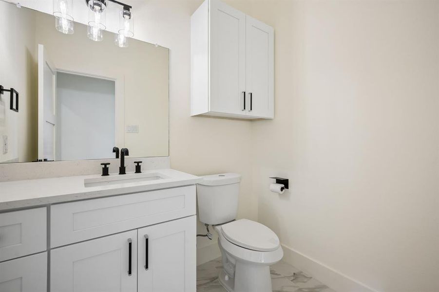 Guest Bathroom featuring vanity and light marble finish floors