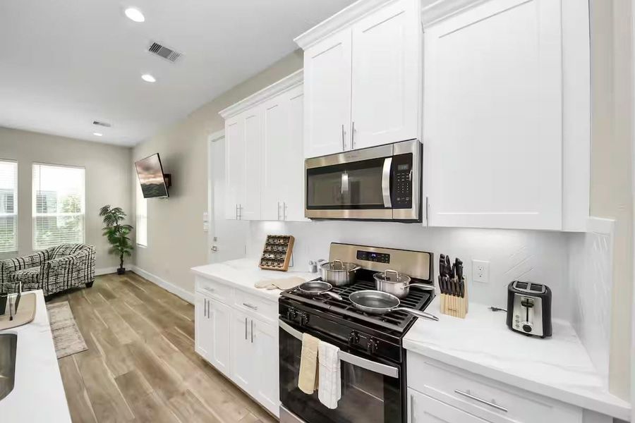 Generous counter space on both sides of the kitchen gives you room to prep and cook while still staying connected to everyone in the living area.