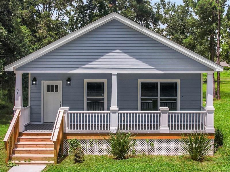 Front exterior of a new home in , Ludowici, GA, highlighting curb appeal (Image 1).