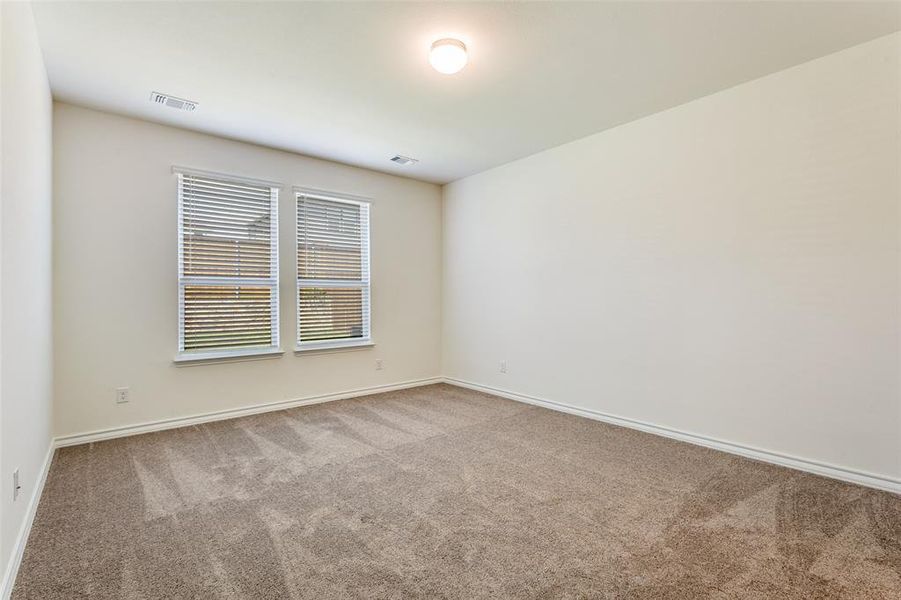 Spare room featuring carpet flooring and baseboards Spare room featuring carpet flooring and baseboards