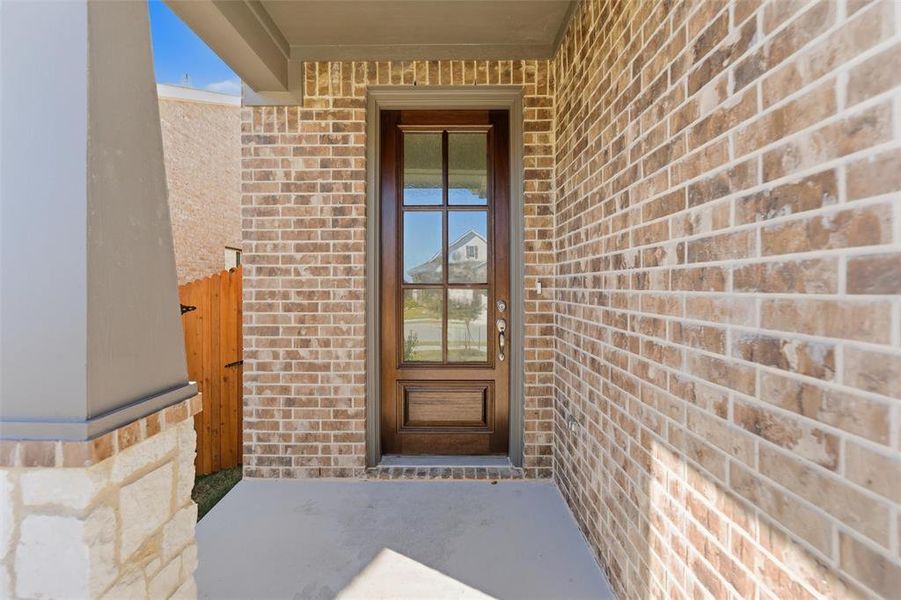 Entrance to property with brick siding