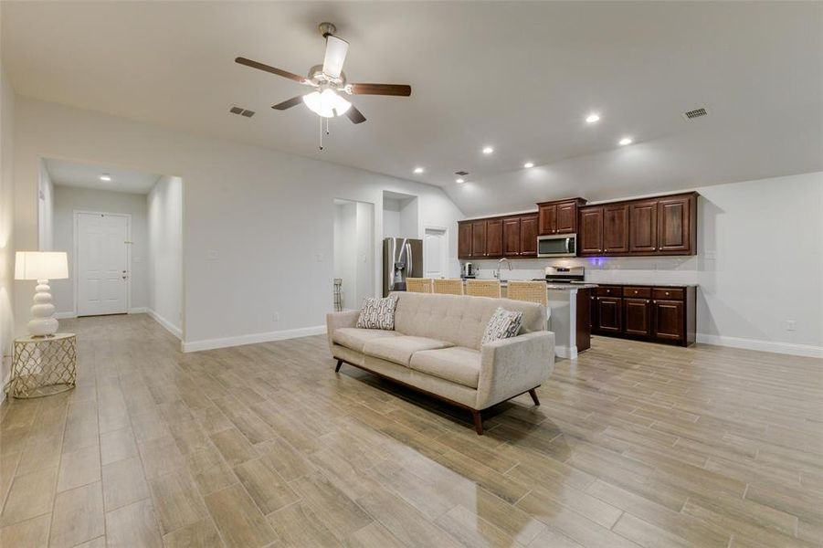 Living room featuring ceiling fan and light hardwood / wood-style floors