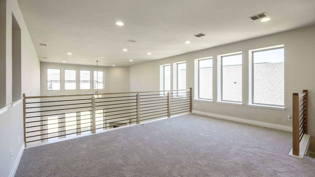 Carpeted spare room with recessed lighting, baseboards, and visible vents Carpeted spare room with recessed lighting, baseboards, and visible vents