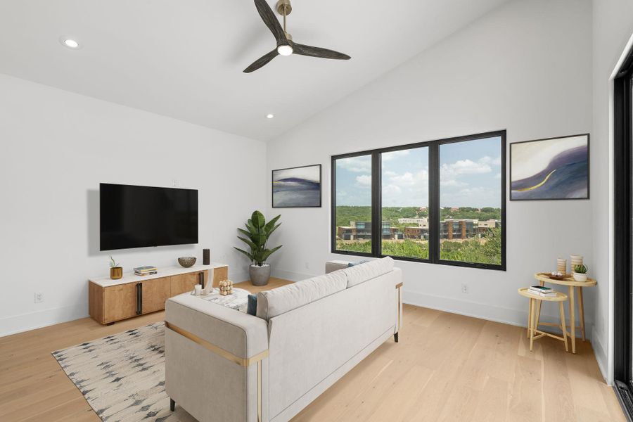 Virtually staged upstairs living room presents a captivating view of the surrounding landscape through a broad, naturally illuminated window.