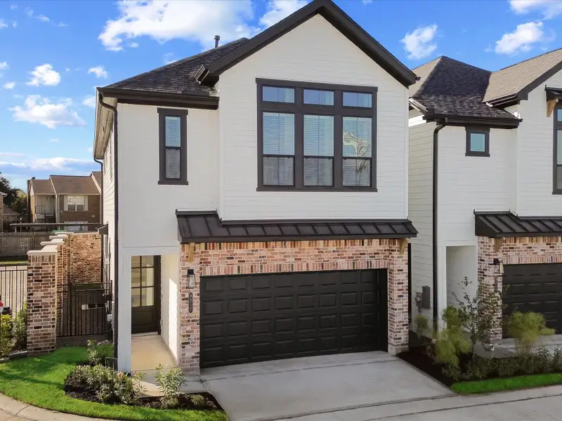Front exterior of a new home in Uptown District, Houston, TX, highlighting curb appeal (Image 2).