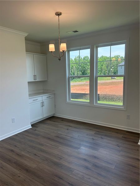 Rich hardwood-style flooring and abundant natural