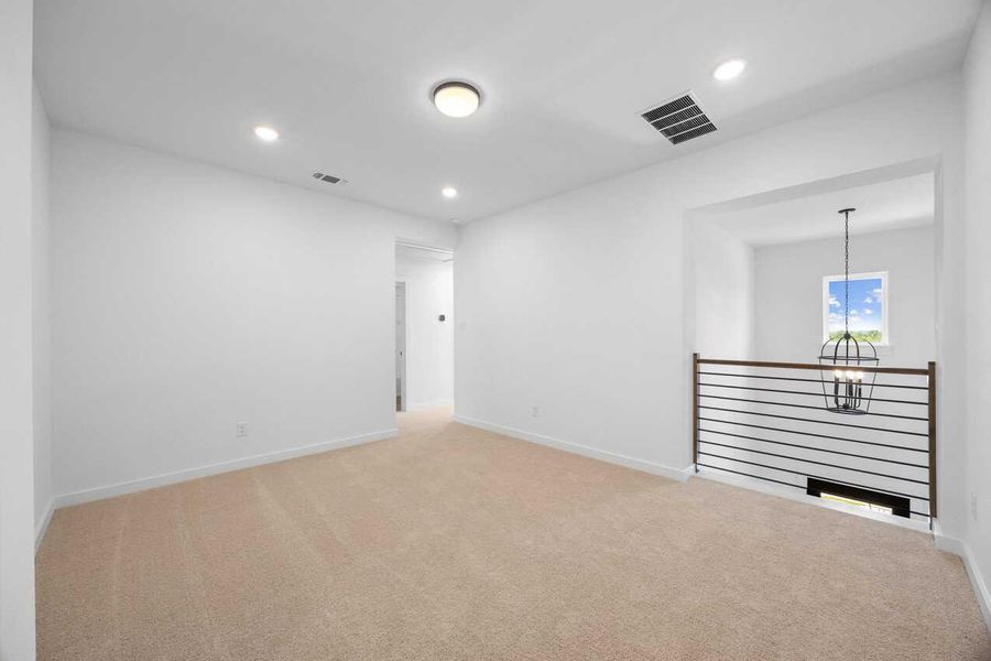Unfurnished room with light colored carpet, recessed lighting, and a chandelier Unfurnished room with light colored carpet, recessed lighting, and a chandelier