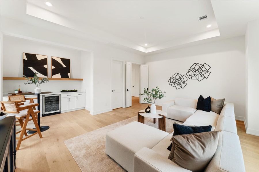 The game room with French doors allows for contained entertainment, so movie nights, gaming sessions, and playdates can happen without affecting the rest of the home. This practical feature makes the space perfect for families with varying activity preferences.