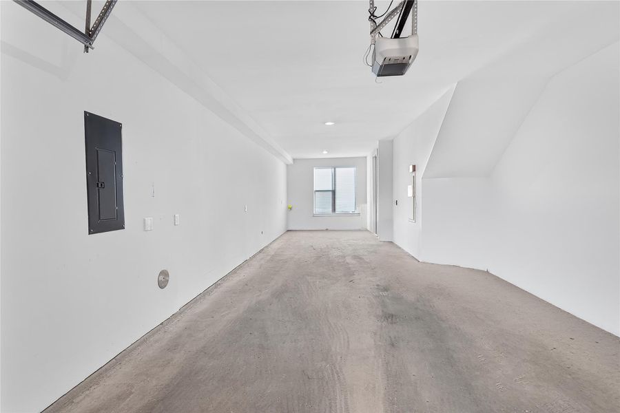 A spacious and pristine garage provides ample parking and potential for storage. The front space could easily be enclosed with HVAC for office, workout or flexroom space