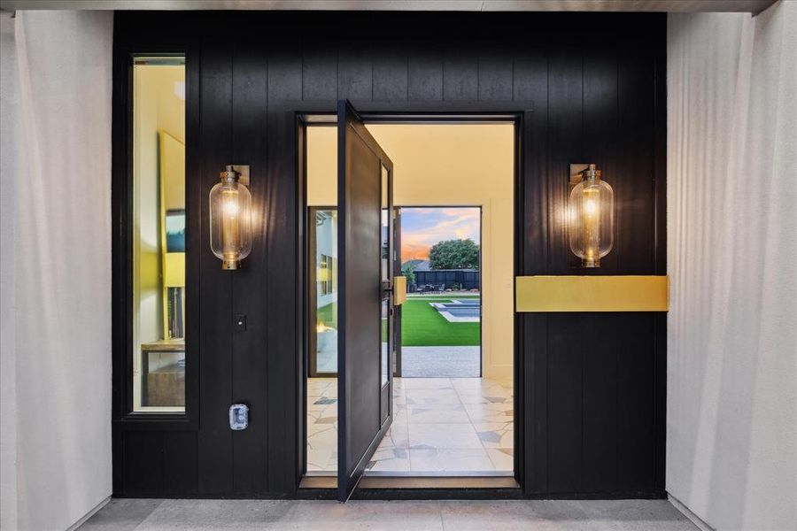 As the front door opens, you're immediately captivated by stunning views of the backyard pool, framed by large windows that invite natural light and create a seamless connection between indoor and outdoor living spaces.