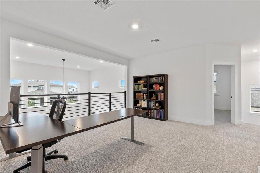 Carpeted office space with recessed lighting and baseboards