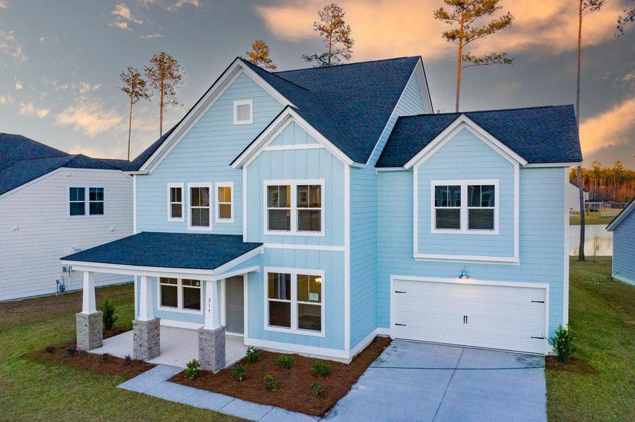 Front exterior of a new home in Waterside at Lakes of Cane Bay: Coastal Collection, Summerville, SC, highlighting curb appeal (Image 14).
