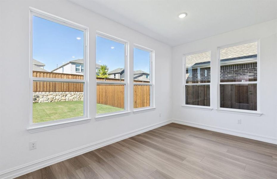 Dining nook off kitchen with large windows