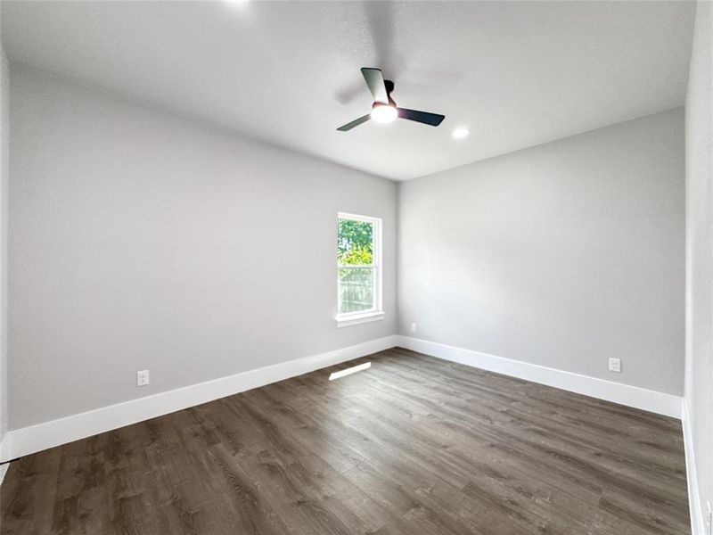 Empty room featuring dark wood-style floors, recessed lighting, and a ceiling fan