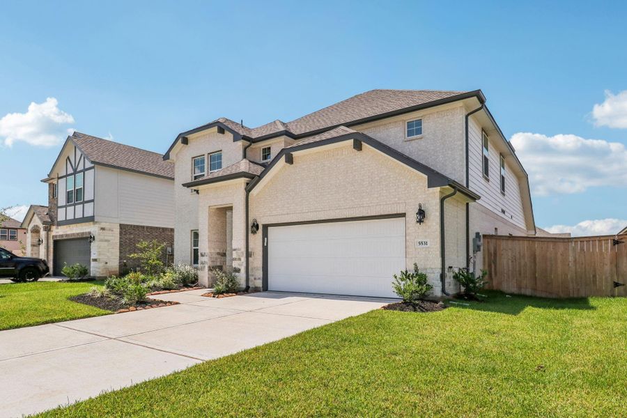 Front exterior of a new home in Kingdom Heights, Rosenberg, TX, highlighting curb appeal (Image 28). Front exterior of a new home in Kingdom Heights, Rosenberg, TX, highlighting curb appeal (Image 28).
