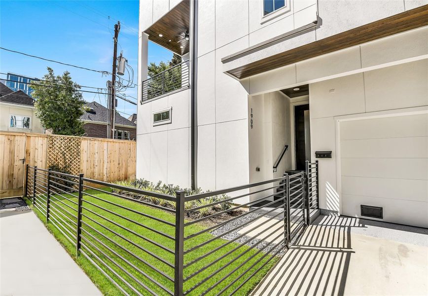 Enjoy the perfect balance of security and serenity with a fully gated front lawn and clean modern fencing. The covered entryway leads to a striking modern front door and a stylish balcony above, setting the tone for a home that blends architectural precision with everyday ease. Perfect for on-call physicians or medical professionals craving a peaceful retreat after long hours at the hospital.