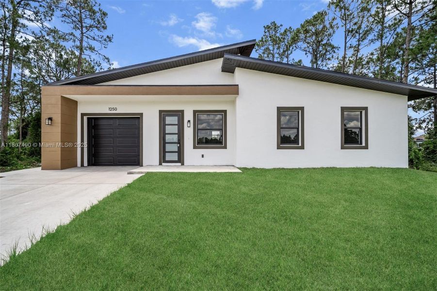 Front exterior of a new home in , Lehigh Acres, FL, highlighting curb appeal (Image 16). Front exterior of a new home in , Lehigh Acres, FL, highlighting curb appeal (Image 16).