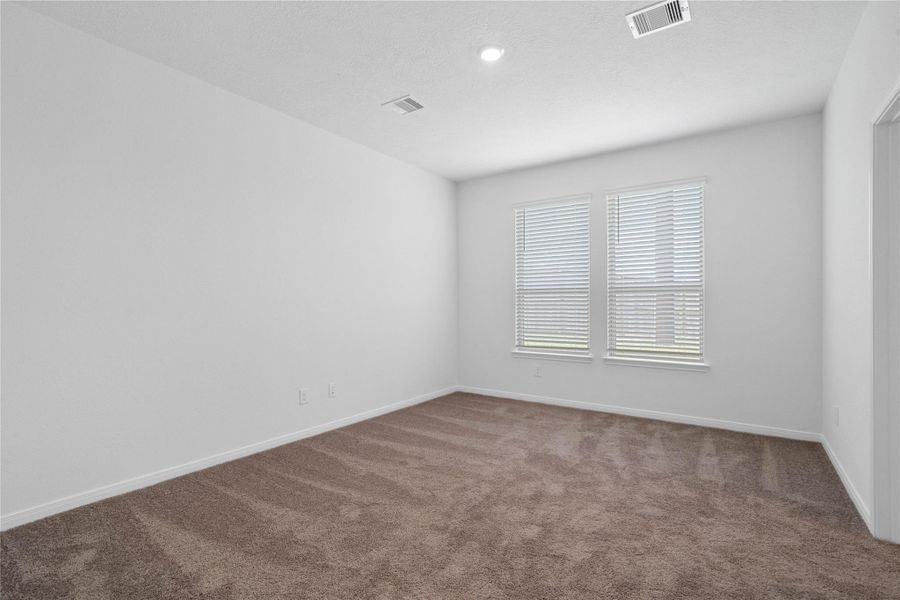 Relax and recharge in this stunning primary suite! Enjoy the comfort of plush carpeting, neutral-toned walls, high ceilings, and expansive windows (fitted with blinds) that fill the room with natural light. Relax and recharge in this stunning primary suite! Enjoy the comfort of plush carpeting, neutral-toned walls, high ceilings, and expansive windows (fitted with blinds) that fill the room with natural light.