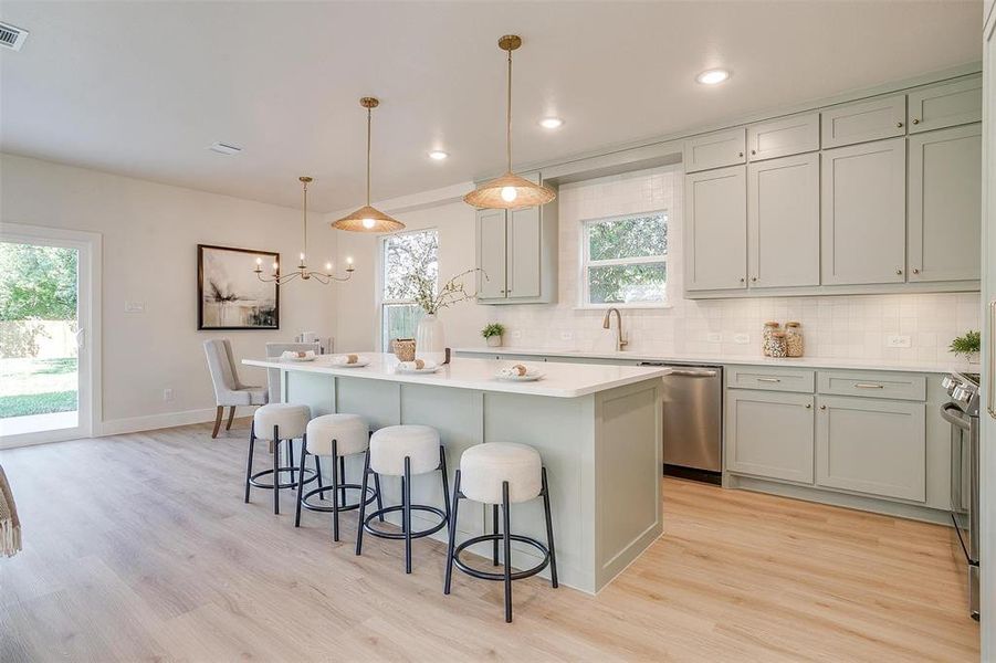 The kitchen features 50" upper cabinetry, a custom crafted venthood, Frigidaire appliances, and designer finishes.