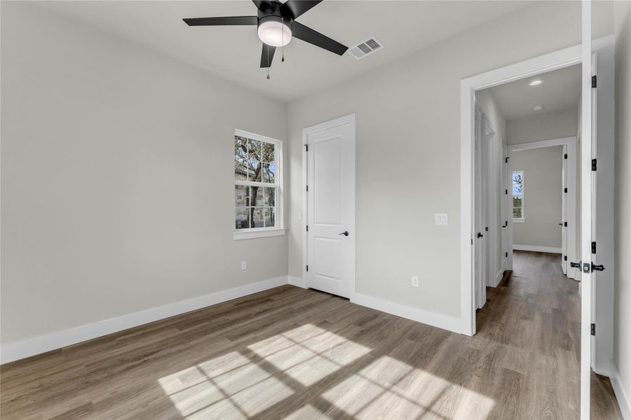 Unfurnished bedroom featuring light wood finished floors and a ceiling fan
