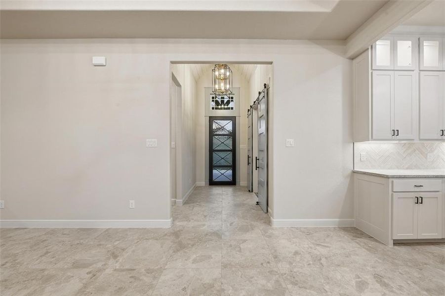 Foyer with baseboards and a chandelier Foyer with baseboards and a chandelier