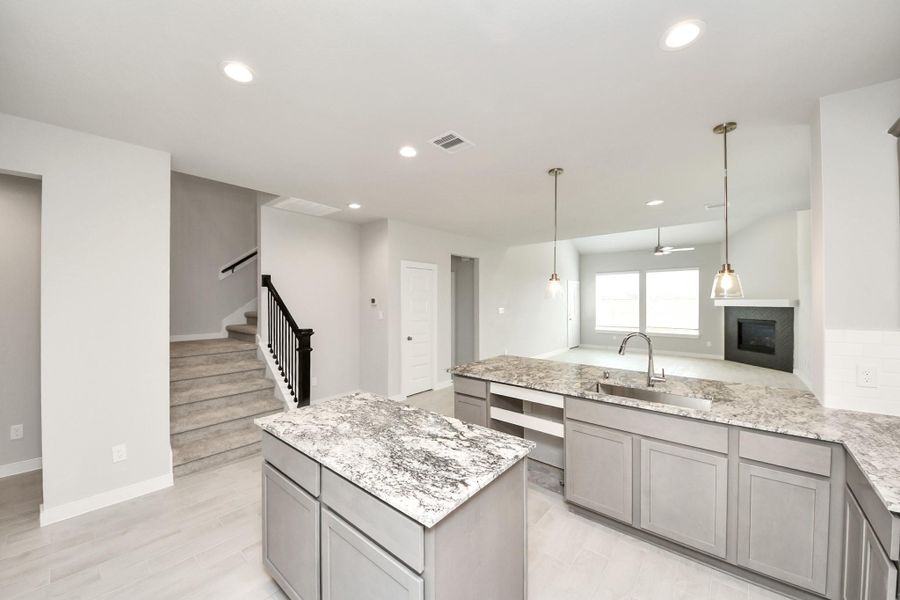 Discover another perspective of this stunning kitchen, generously appointed with an abundance of counter space. Sample photo of completed home with similar floor plan. Actual colors and selections may vary. Discover another perspective of this stunning kitchen, generously appointed with an abundance of counter space. Sample photo of completed home with similar floor plan. Actual colors and selections may vary.