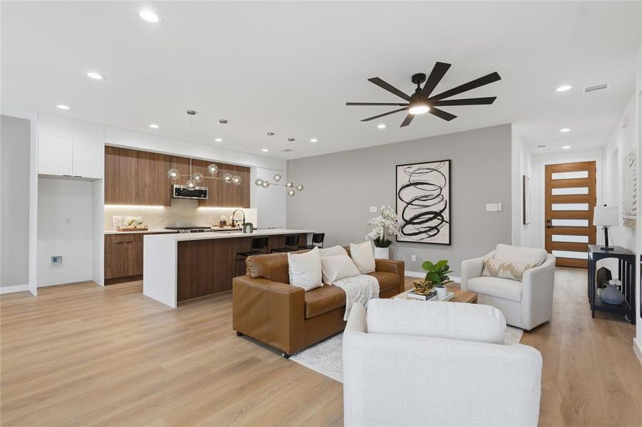 Living room featuring recessed lighting, light wood finished floors, and a ceiling fan Living room featuring recessed lighting, light wood finished floors, and a ceiling fan