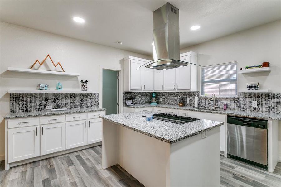 Kitchen featuring open shelves, dishwasher, white cabinets, light stone counters, and recessed lighting Kitchen featuring open shelves, dishwasher, white cabinets, light stone counters, and recessed lighting