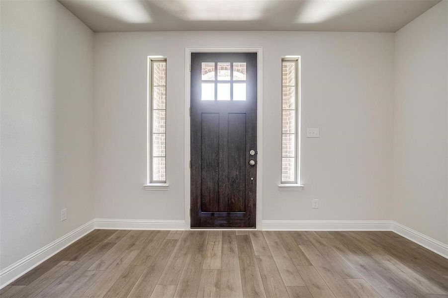 Entrance foyer featuring light wood-style floors and baseboards