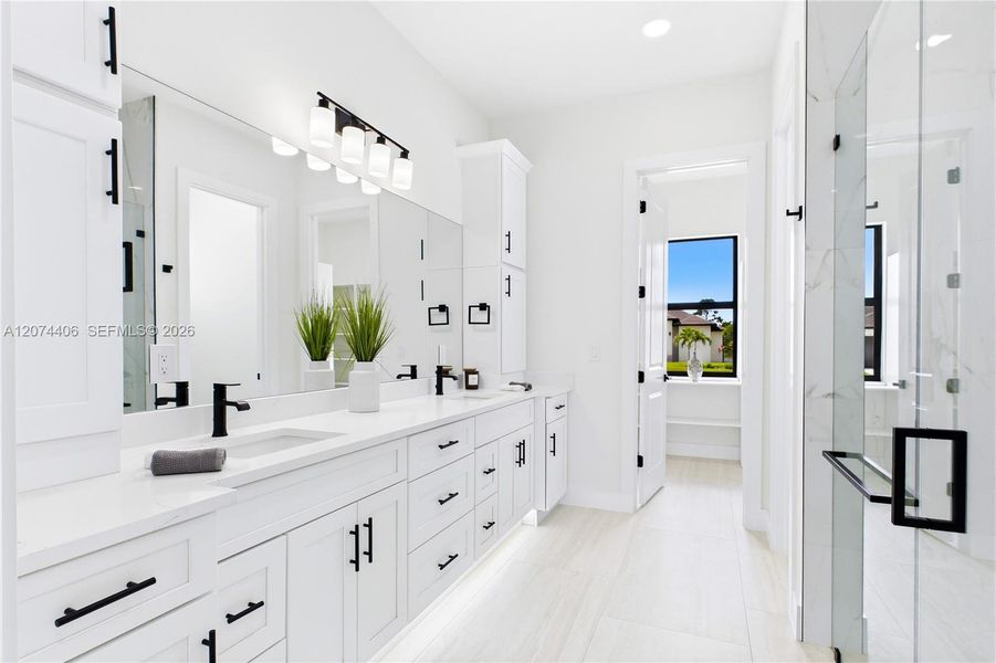 Dual sink vanity w/ quartz countertops, sleek white cabinetry & contemporary lighting complements the spa-like design Dual sink vanity w/ quartz countertops, sleek white cabinetry & contemporary lighting complements the spa-like design