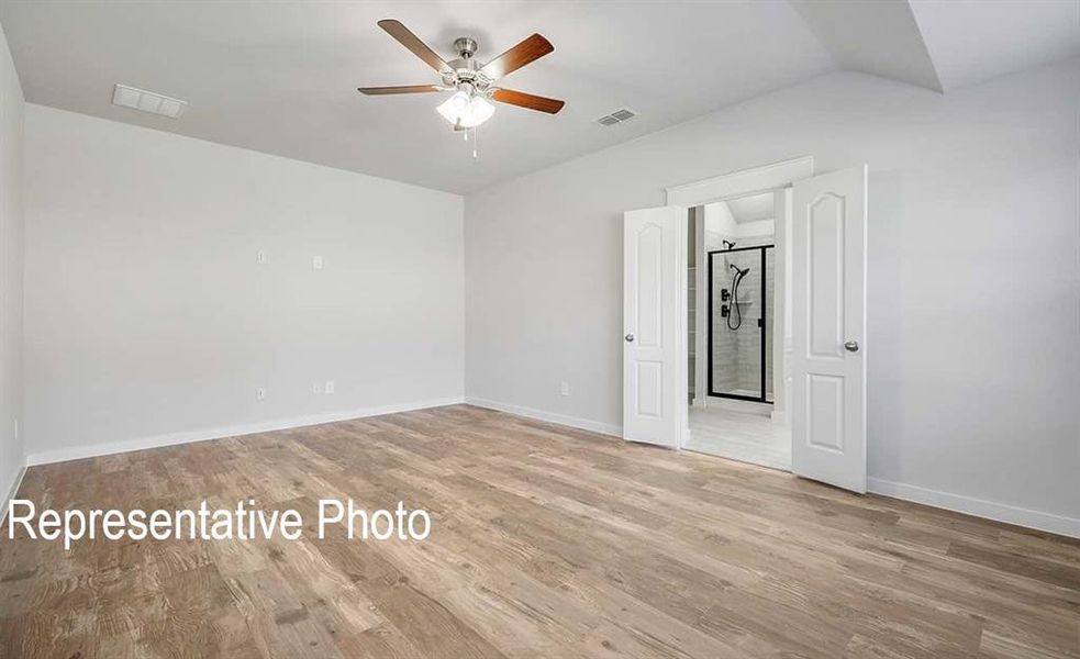 Unfurnished room featuring ceiling fan, light hardwood / wood-style flooring, and lofted ceiling