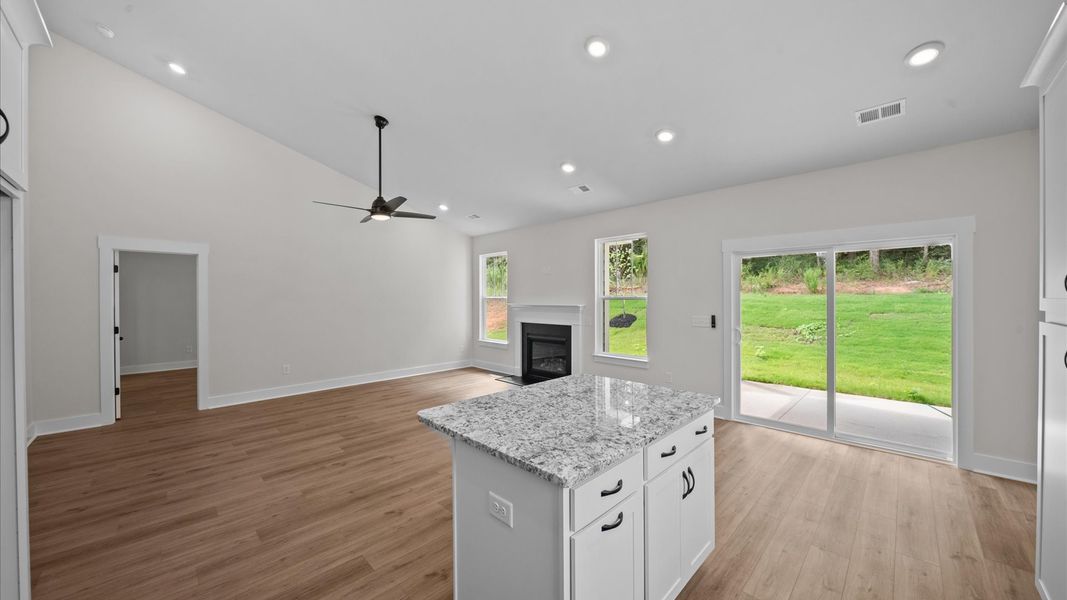 Highly skilled design choices create a clean, open kitchen with a central island