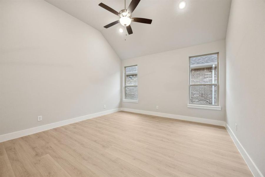 Unfurnished room with ceiling fan, high vaulted ceiling, and light wood-type flooring