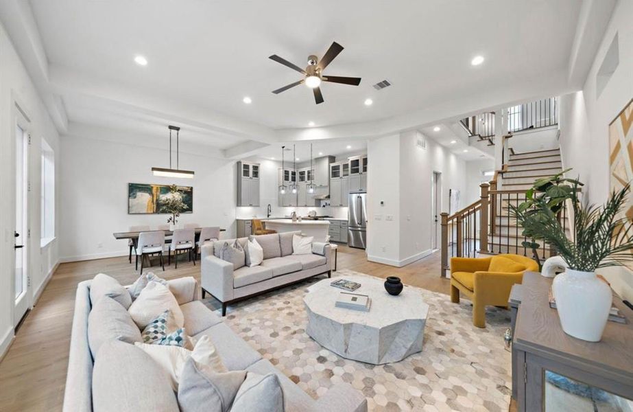 Riverway Homes are celebrated for soaring ceilings and exquisite details. This image showcases open-concept living in a beautifully finished Riverway home.Photos depict a completed Riverway Home; this home is under construction and finishes may vary.