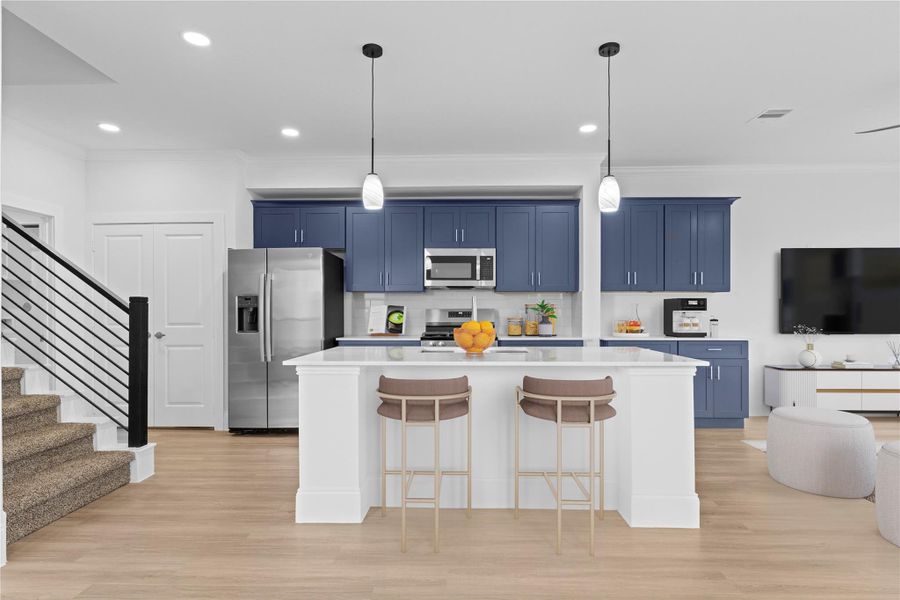 The gourmet kitchen is a cook's dream come true! Large working station island with gorgeous sparkling quartz countertops.  Stainless steel side by side refrigerator with ice and water dispenser.  Boast beautiful pendant lighting above.  French door open to the outstanding pantry for all your storage needs!  This home is just calling your name!  ** virtual stage**