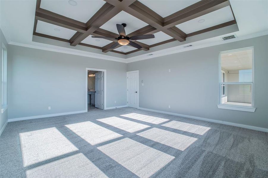 Unfurnished bedroom with crown molding, coffered ceiling, ceiling fan, carpet floors, and beam ceiling Unfurnished bedroom with crown molding, coffered ceiling, ceiling fan, carpet floors, and beam ceiling