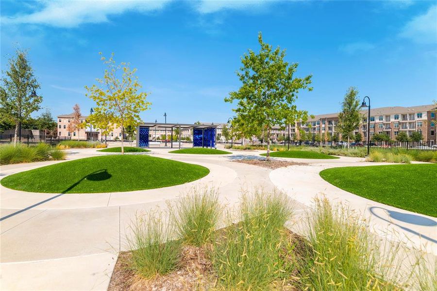 View of property's community with a lawn